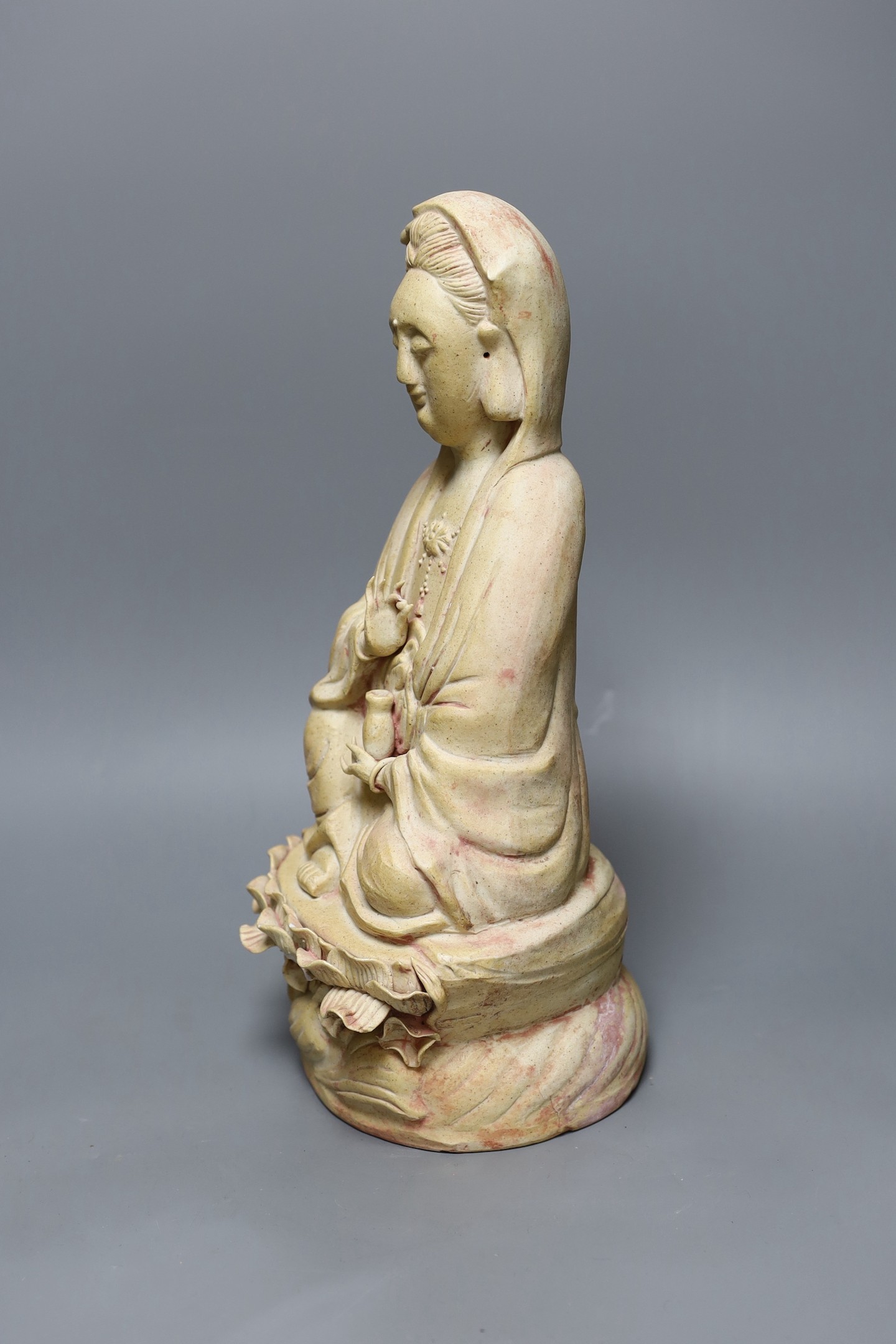 A Chinese biscuit figure of Guanyin, 38 cms high